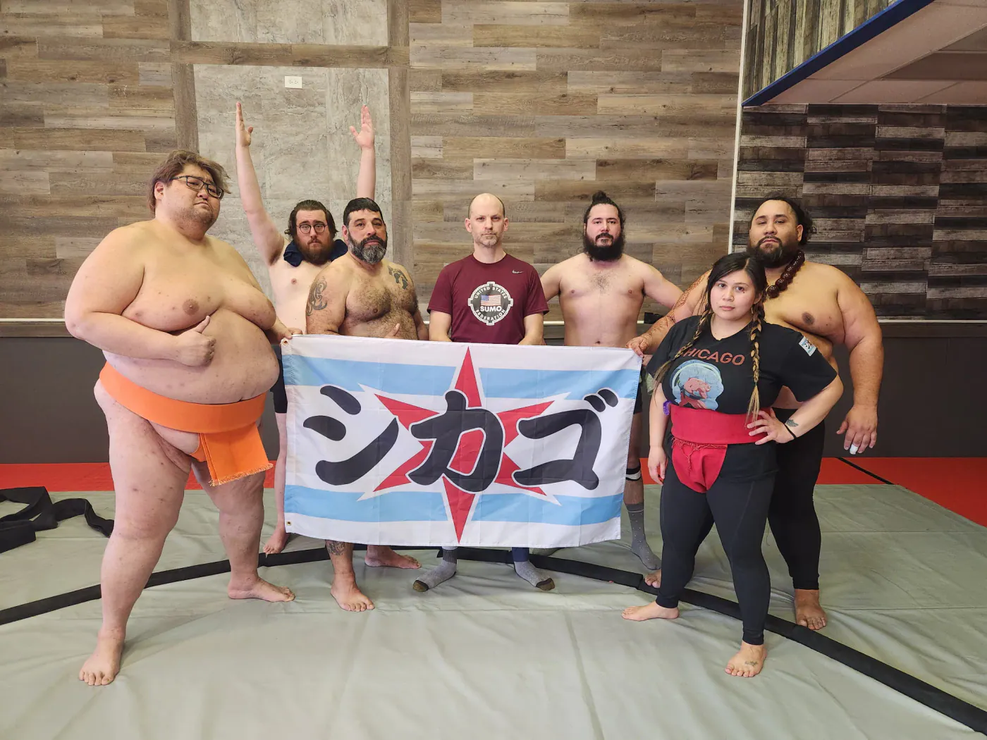 Club members holding a Chicago flag banner with the city name in Japanese
